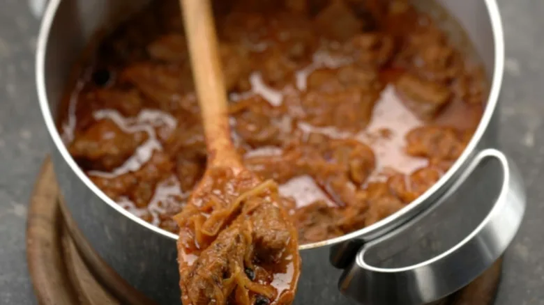 Hot traditional Czech segedin served in metal cooking pot.