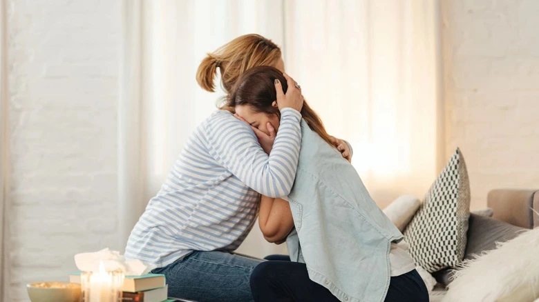Woman comforting crying woman