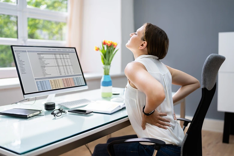 Woman with back pain at desk