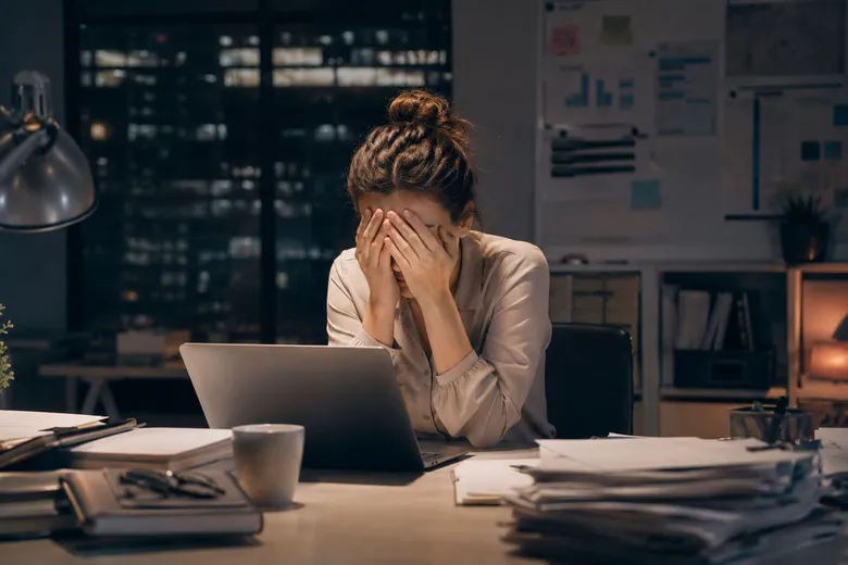 Exhausted woman at desk