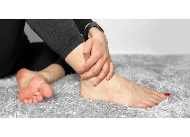 Person holding ankle in pain
