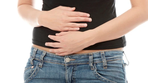 Person holding stomach in pain